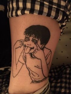 a woman's leg with a black and white drawing of a boy on it