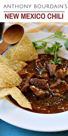 a white plate topped with meat and tortilla chips