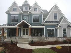 a large gray and white house with lots of windows