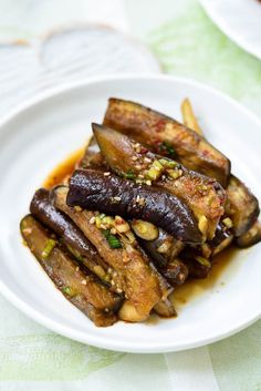 an eggplant dish is served on a white plate