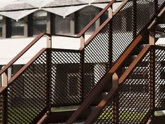 an image of some metal stairs going up to the top one and another building in the background