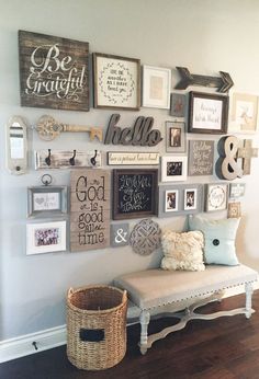 a wall filled with lots of different types of framed pictures and letters on it's side