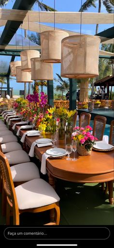 a long table with chairs and flowers on it