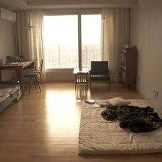 a bedroom with a bed, desk and chair in the corner next to a sliding glass door