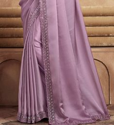 COLOR : Mauve FABRIC : Saree - Satin Silk, Blouse - Satin Silk & Net WORK : Resham Embroidery, Stones, Sequins, Lace BorderOCCASION : Wedding, Engagement, Party Wear, Festival, Sangeet NOTE : The outfit includes blouse and saree only. Petticoat is not included. READY-TO-WEAR : No STITCHING : Available as semi-stitched fabric, can be stitched using standard size option (+$30). Note: There might be a slight color variation due to lighting and flash used during photoshoot. The bright shade seen is the best closer view of fabric's color. Reception Georgette Sets With Embroidered Border, Elegant Purple Sets With Embroidered Border, Elegant Fitted Saree With Embroidered Border, Reception Saree With Embroidered Border In Chinon, Chinon Saree With Embroidered Border For Reception, Anarkali Saree With Intricate Embroidery For Ceremony, Elegant Purple Georgette Embroidered Fabric, Elegant Purple Embroidered Georgette Fabric, Reception Saree With Embroidered Border