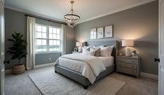 a bedroom with gray walls and white bedding