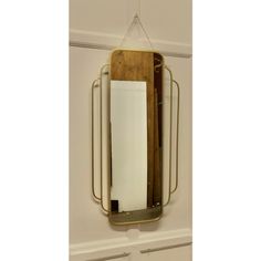 a mirror hanging on the wall next to a cutting board