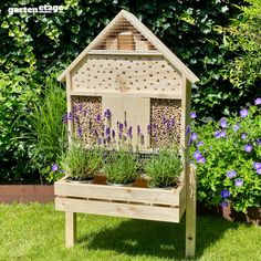 a wooden bird house with plants growing in it