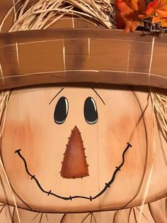 a close up of a wooden scarecrow face