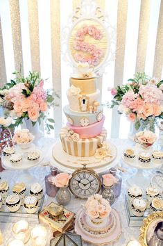 a table topped with lots of cakes and cupcakes