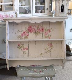 an old china cabinet with flowers painted on it