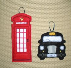 a red phone booth sitting next to a black and white car shaped ornament