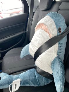 a stuffed shark in the back seat of a car