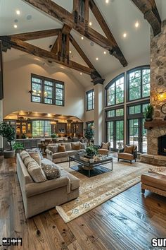 a large living room with wood floors and high ceilings