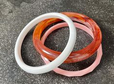 Beautiful set of pink and white acrylic bangle bracelets. These fun, vibrant bracelets will add a lovely pop of color to any outfit! Pink Plastic Bangle Bracelet, Pink Plastic Bangle Jewelry, Bracelets Vintage, Bangle Bracelet Set, Heart Shaped Earrings, Ring Photos, White Acrylic, White Acrylics, Gorgeous Jewelry