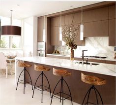 a kitchen with marble counter tops and bar stools