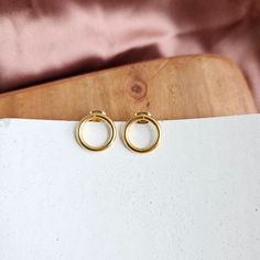 Introducing our Oriana Studs – the perfect blend of elegance and minimalism, designed to effortlessly elevate your everyday style with a touch of timeless charm! ✨ Add some classic elegance to your life and let these studs become a part of your signature style. 18k gold-plated stainless steel Hypoallergenic Tarnish resistant Waterproof Minimalist Earrings With Timeless Design As Gift, Classic Everyday Jewelry With Timeless Design, Minimalist Yellow Gold Earrings Timeless Design, Matte Gold Minimalist Jewelry For Anniversary, Minimalist Timeless Yellow Gold Earrings, Classic 14k Gold Open Circle Jewelry, Classic Rose Gold Circle Jewelry, Classic Circle Earrings For Everyday, Minimalist 14k Gold Jewelry With Classic Design