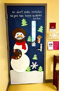 a door decorated with a snowman holding a brush