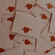 many envelopes with red hearts on them