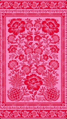 a red and pink floral design on fabric