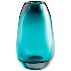 a blue glass vase sitting on top of a white table