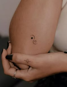 a woman's belly with a small star tattoo on her left side ribcage