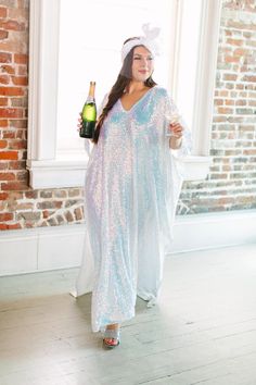 Be the life of the party in this long sequin caftan! This show-stopping caftan is adorned with shimmering sequins that will catch the light and turn heads. With a flowy, relaxed fit, it combines style and comfort. The long length ensures you'll bring the fashion drama, while the sequins add a touch of glamour to your look. These comfortable sequins on mesh are ulined for maximum breeze. Summer Festive Sequined Kaftan, Summer Party Sequined Kaftan, Summer Party Sequin Kaftan, Summer Party Kaftan With Sequins, Spring Party Kaftan With Sequins, Festive Sequin Maxi Length Kaftan, Festive Maxi-length Sequined Kaftan, Sequined Summer Evening Kaftan, Sequin V-neck Wedding Kaftan