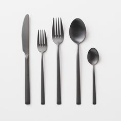 five forks, two spoons and one knife on a white surface