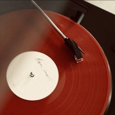 an old record player with red and black vinyl