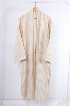 These natural beige striped robes are made from our handwoven linen/cotton peshtamals. They are soft, extremely absorbent, quick-drying and multifunctional. Use as bathrobe after shower, as cardigan at breakfast in the morning or worn as a duster jacket over jeans. Materials are cotton and linen. All of our robes are unisex. Care Instructions Please wash it before the first usage. They are machine washable but only at a cold temperature. Never use bleach or fabric softener. We recommend that han Striped Long Sleeve Robe For Loungewear, Beige Cotton Robe For Daywear, Long Sleeve Cream Robe For Home, Cream Long Sleeve Home Robe, House Wear, Cotton Loungewear, Duster Jacket, Shades Of Beige, Closet Essentials