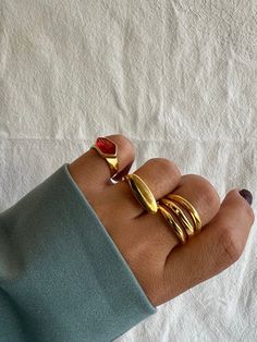 Three  different handmade rings for women with gold bands and unique designs that create a really unique set. The first one is a gold ring with a red stone from peweter on it. The middle one is a gold oval ring and the last one is a gold triple ring that catches the eyes. All these rings are slightly adjustable. You can wear them all together or separetely as well. Find them only at Christina Christi Store. 👉 My Rings Collection: https://etsy.me/2z6Fby0 👉 Express Shipping: https://etsy.me/3ikU Gold Rings Women, Gold Oval Ring, Triple Band Ring, Handmade Gold Ring, Triple Ring, Rings Women, Rings Collection, Gold Statement Ring, Oval Ring