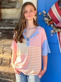 This is a favorite throw on and go top. A casual top to go with anything. I'm loving the color block with stripe details, the contrast stitching, along with the button henley, is perfection. The buttons are wood, but not functional. It would pair great with jeans and shorts. You could wear this for an unconventional Americana shirt. Runs a little large. If in between sizes, size down. Sizes: Small-XLarge (Small fits 4-6, Medium fits 8-10, Large fits 12-14, Xlarge fits 16-18) Color Block Top, Casual Top, Casual Tops, Color Block, Open Shoulder Tops, Ruffle Blouse, Stitching, Wood, Women's Top