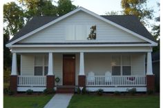 a white house with red trim and front porch