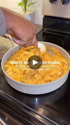 a person is spooning food out of a bowl on top of the stovetop