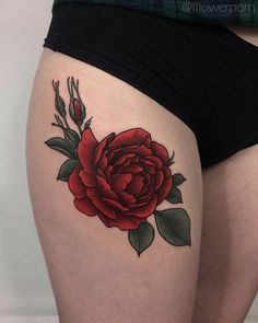 a woman's thigh with a rose tattoo on it