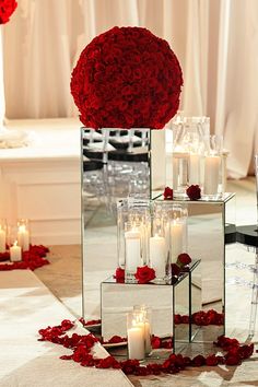 the centerpieces are filled with roses and candles