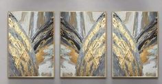 three abstract paintings hanging on the wall