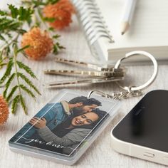 a cell phone and keychain sitting on a table