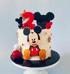 a mickey mouse cake on a black and white plate