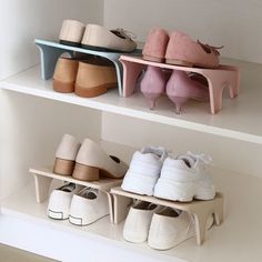 three shelves with shoes on them and one shelf holding several pairs of shoes in it