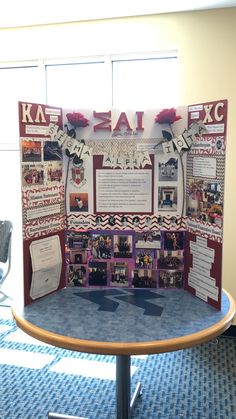 a bulletin board with pictures on it in the middle of a conference room table area