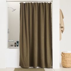 a bathroom with a brown shower curtain next to a bath tub