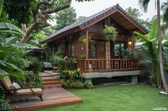 a small wooden house sitting on top of a lush green field with lots of trees