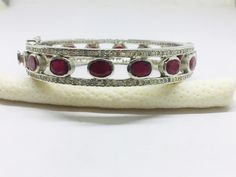 Listing is for (1) one beautiful Solid sterling silver 925 two tone pave diamond ruby bangle (price for one psc.) diamond wt: 2.1 cts. silver wt: 45 gms. stone wt: 8 cts. Gemstone name:- Diamond Ruby It's a beautiful bracelet (bangle). two tone pave diamond ruby bangle perfect for summers. Light weight . perfect for gifting and wedding. We keep on adding new products & designs every day so keep coming back to get more deals & designs. Bulk & wholesale orders are welcome on this desig White Gold Gemstone Bangle Fine Jewelry, Fine Jewelry White Gold Gemstone Bangle, White Gold Gemstone Diamond Bangle Bracelet, White Gold Gemstone Bangle, White Gold Diamond Bangle Bracelet With Gemstone, Silver Diamond Bangle With Pave Setting, Diamond Bangle Fine Jewelry Hallmarked, Oval Bangle With Diamond Accents In Fine Jewelry Style, White Gold Bangle With Pave Setting