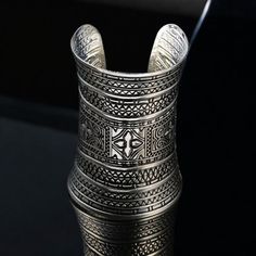 ❖Antique Bracelet, Ethnic Tribal Bracelet, Sliver Bangle, Statemen Cuff, Ceremonial Gift, Wedding Present❖ One Size Fits All What is included?  1x Cuff An silver cuff adorned with intricate embossed patterns, featuring a blend of geometric and floral designs that showcase traditional craftsmanship. High Quality Craftsmanship  Geometric and Floral Design 30 Day Money Back Guarantee My family has dedicated over 8 years to crafting quality products. Every product is made with care and attention to detail. Your support means the world to us as we continue to pursue our passion. ❖Note: Due to the nature of the manufacturing process and image quality, there might be slight variations in color. However, this doesn't affect the quality of the product.❖ Antique Bracelets, Wedding Present, Silver Cuff, Manufacturing Process, Gift Wedding, Floral Designs, Favorite Jewelry, Bangle Bracelets, Floral Design