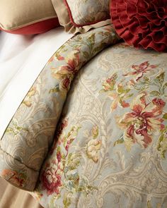 the comforter is made up with red and green flowers on it's side