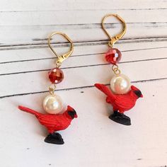 Miniature majestic red cardinal holiday earrings that are both fun and sophisticated. Faux pearls and a shimmering deep ruby electroplated faceted bead bring the bling and sophistication to these simple minimalistic festive bird earrings. Unique holiday statement earrings to get you in the festive holiday spirit! Very lightweight with gold-plated, nickel-free lever back ear hooks.  Makes the best gift for bird and cardinal lovers!  Thanks for looking! ~Lightweight earrings with a dainty 2-inch drop. ~Make it a set with the Candace the Cardinal Pearl Queen Mum! https://etsy.me/3ULtRfm Festive Red Pearl Drop Earrings, Red Pearl Drop Earrings For Festive Occasions, Elegant Holiday Jewelry With Matching Earrings, Elegant Holiday Dangle Earrings, Red Jewelry For Holiday Jewelry Making, Red Pearl Drop Jewelry For Festive Occasions, Red Dangle Pearl Earrings For Festive Occasions, Red Dangle Pearl Earrings For Party, Red Pearl Drop Earrings For Party