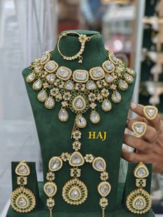 a green display case with jewelry on it