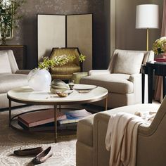 a living room with couches, chairs and a coffee table in front of a mirror