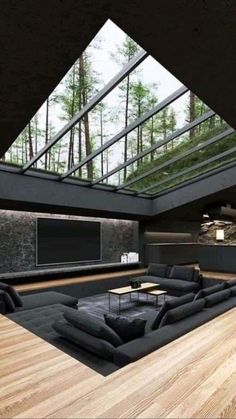 a large living room with wooden floors and skylights